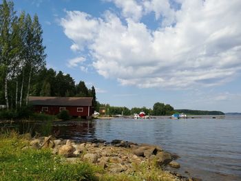 Scenic view of lake by building against sky