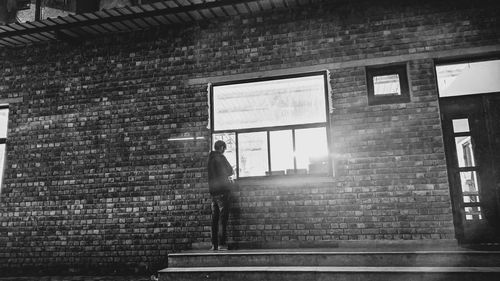 Rear view of man walking on wall