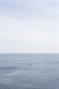 Boat sailing on sea against sky