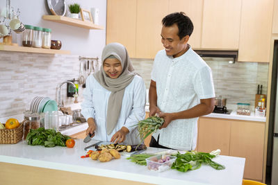 Woman standing by food at home