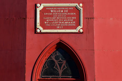 Close-up of text on red wall