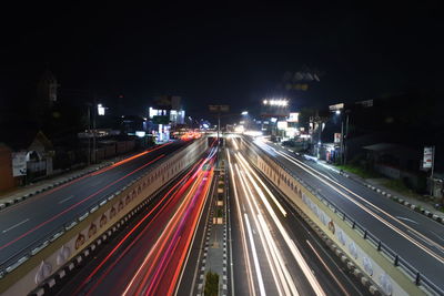 High angle view of light trails on highway at night