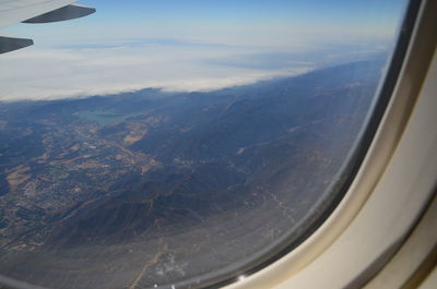 Aerial view of landscape seen through airplane window