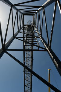 Low angle view of steel structure against sky with white clouds , steel truss in black color 