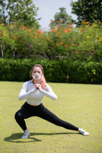 Beautiful chinese girl wearing n95 face mask while working out