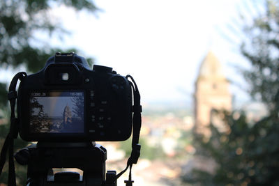 Close-up of camera against trees