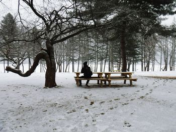 Man on snow covered landscape against sky