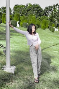 Portrait of smiling young woman standing on land