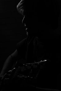 Rear view of man looking at camera