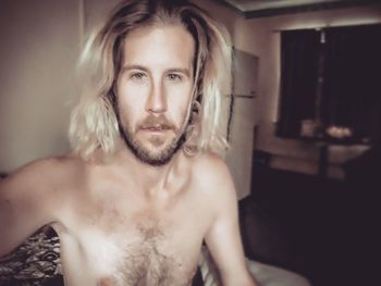 Portrait of shirtless mid adult man at home