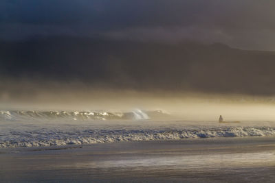 Scenic view of sea against sky during winter