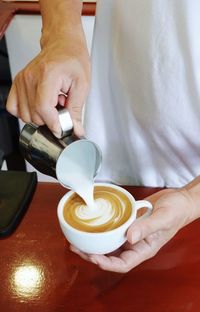 Midsection of man holding coffee