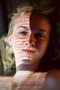 Close-up portrait of woman with shadow of body