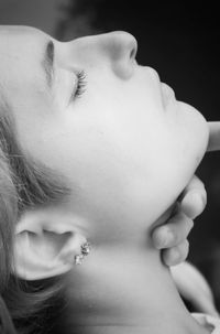 Close-up portrait of woman with eyes closed