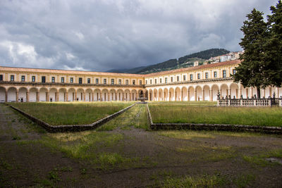 View of old building against cloudy sky