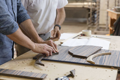 Employee checking curve frame while standing at factory