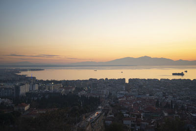 High angle view of buildings in city against sky during sunset