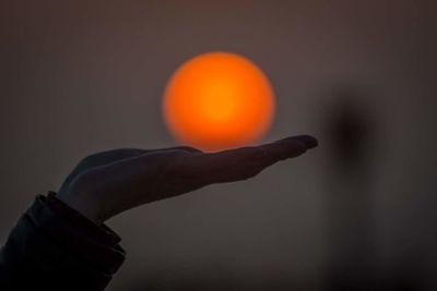 Close-up of hand holding sun