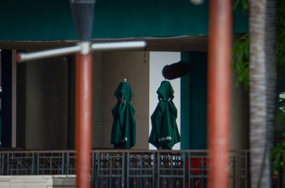 Clothes hanging on railing by fence