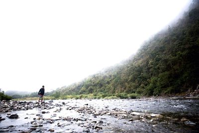 Full length of woman standing on mountain