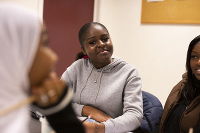 Portrait of smiling girl sitting in classroom