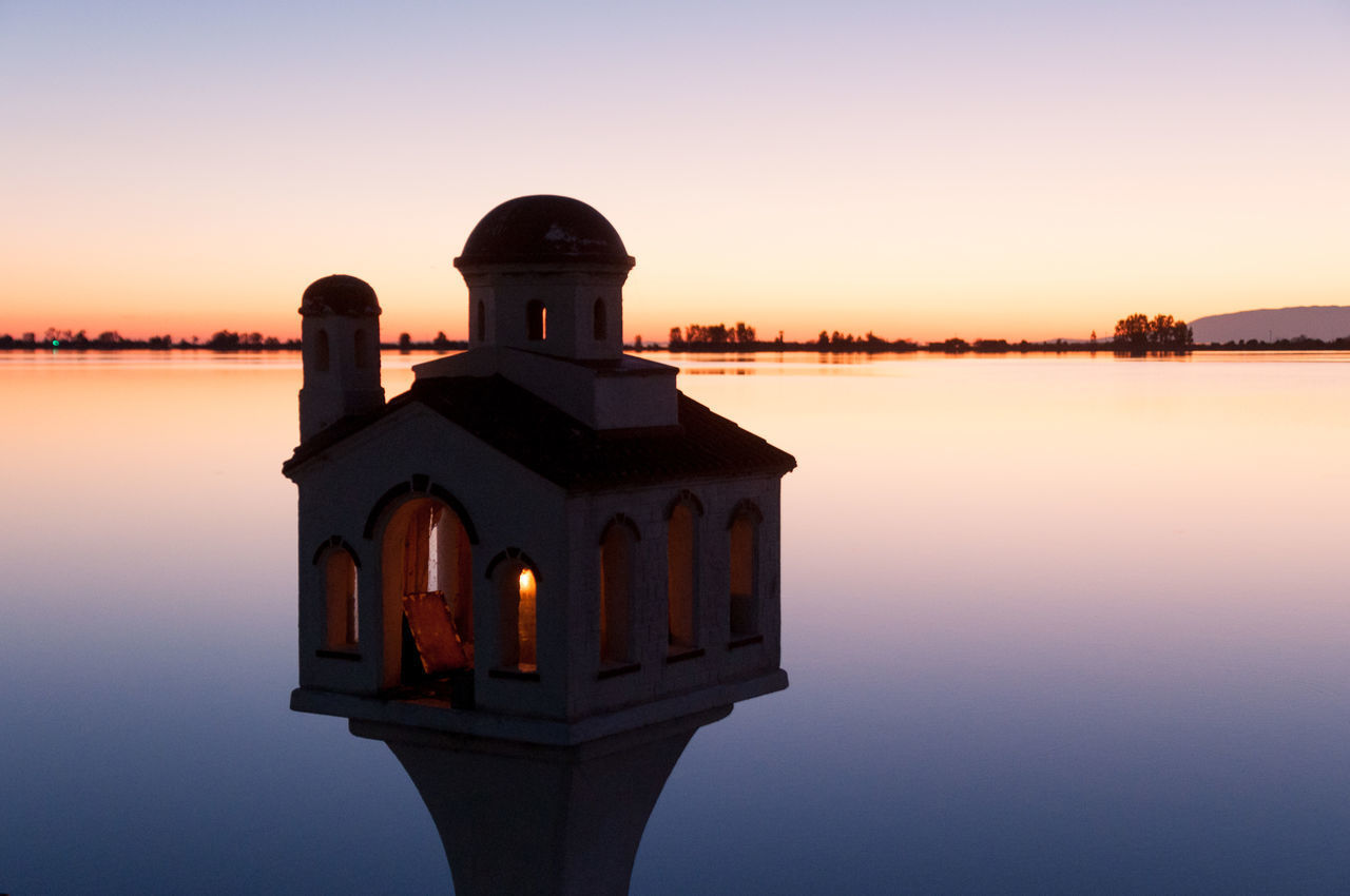 BUILT STRUCTURE AGAINST CLEAR SKY AT SUNSET