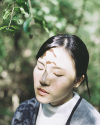 Close-up of young woman with eyes closed