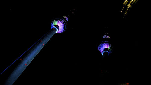 Low angle view of illuminated tower at night