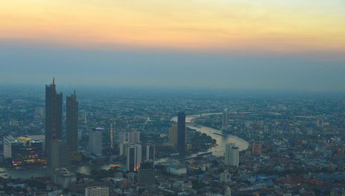 High angle view of city buildings during sunset