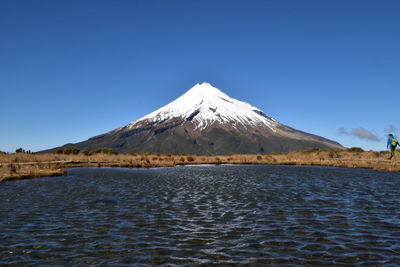 Scenic view of snowcapped mountains against clear blue sky