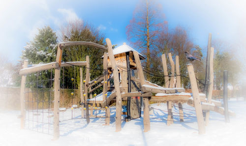 Gazebo on field against sky during winter