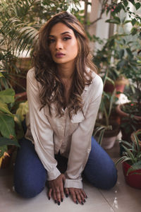 Portrait of a young woman sitting outdoors