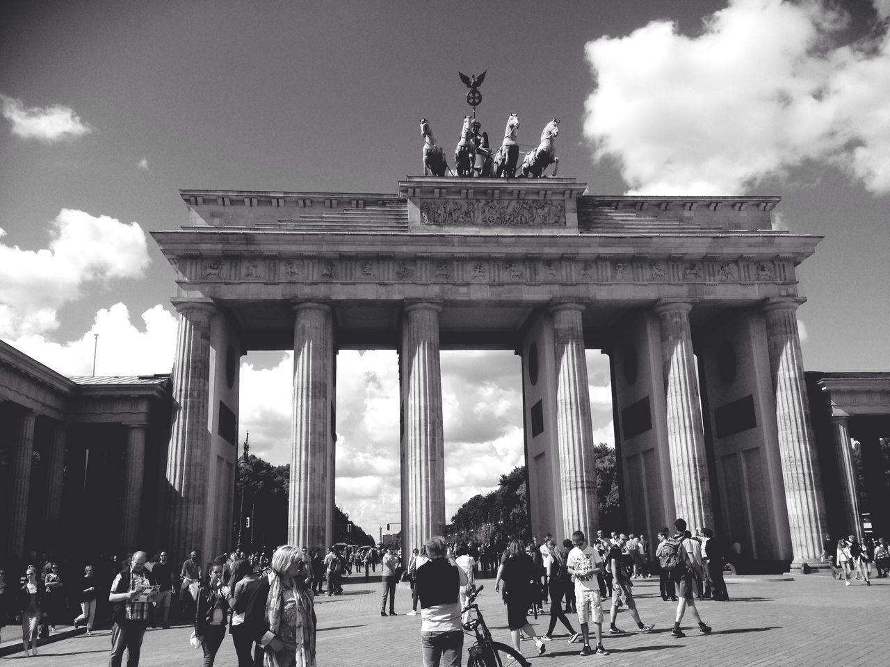 architecture, large group of people, built structure, sky, famous place, person, building exterior, travel destinations, tourism, cloud - sky, men, tourist, architectural column, history, travel, sculpture, mixed age range, statue, international landmark