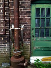 Close-up of pipe against brick wall