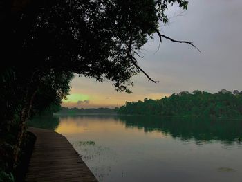 Scenic view of lake against sky at sunset