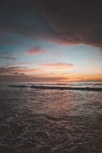 Scenic view of beach against sky during sunset