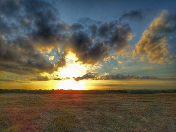 Scenic view of dramatic sky over field