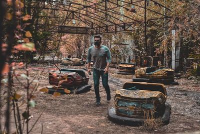 Man walking at abandoned amusement park