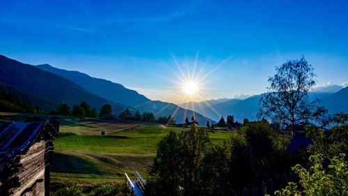 Scenic view of landscape against blue sky