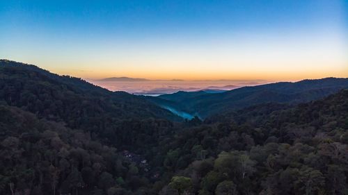 Scenic view of mountains against sky at sunset