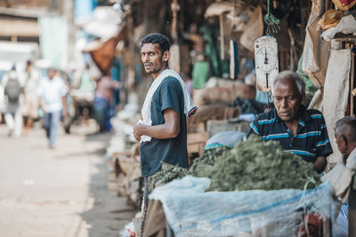 Portrait of people on street in city