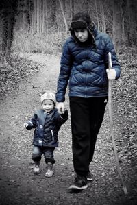 Full length of mother and daughter walking on tree