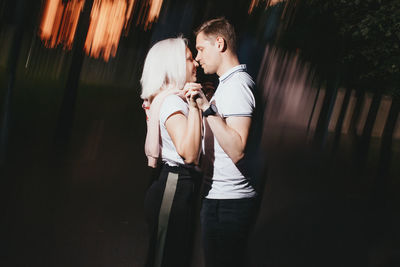 Romantic couple standing against blurred background