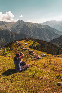 A tourist taking a photo on the pokut plateau, which borders rize province in the black sea 