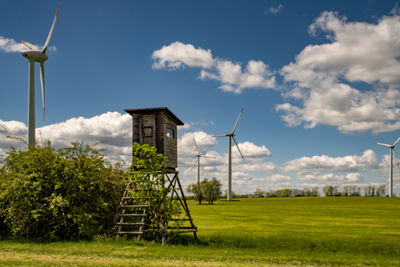 Traditional windmill on field against sky