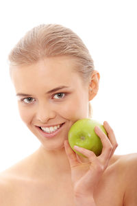 Portrait of a smiling young woman against white background