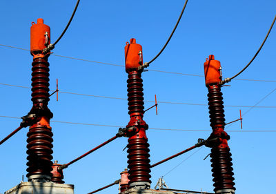 Low angle view of electricity pylon against sky