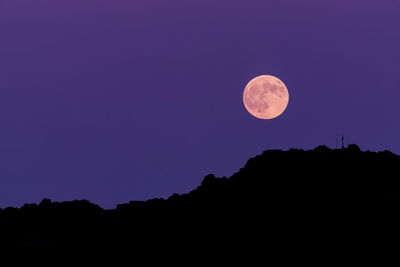 Low angle view of moon in sky at night