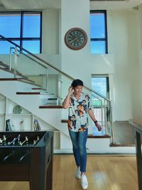 Full length portrait of girl standing at home