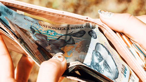 Midsection of woman holding paper currency